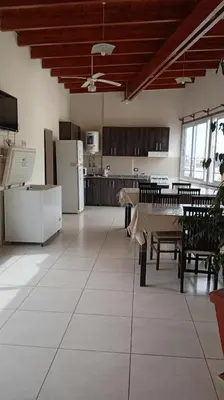 a large kitchen and dining room with a table and chairs at Sam Mira 1 in Villa Carlos Paz