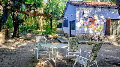 a table and chairs in front of a building at Casa Megafó no in Las Rabonas