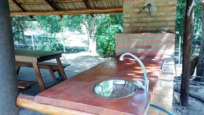 a wooden table with a metal bowl on top of it at Casa Megafó no in Las Rabonas