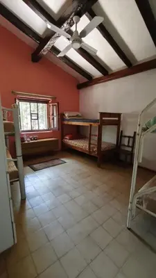 a room with two bunk beds and a ceiling fan at Casa Megafó no in Las Rabonas