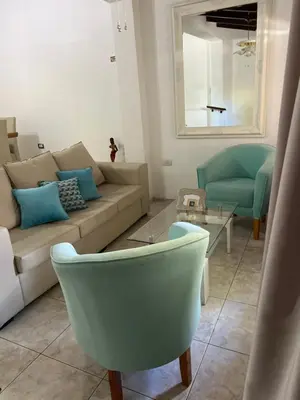 a living room with a couch and a chair at Casa céntrica in Villa Carlos Paz