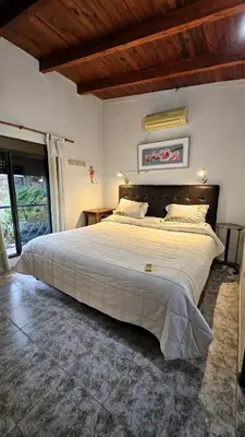a bedroom with a large bed in a room at CASA PARA 5 CON PILETa in Villa Carlos Paz