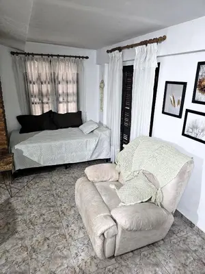 a living room with a couch and a bed at CASA PARA 5 CON PILETa in Villa Carlos Paz