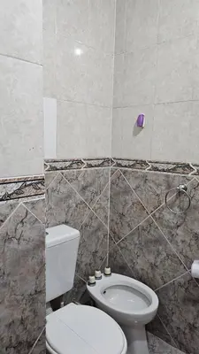 a bathroom with a white toilet and a sink at CASA PARA 5 CON PILETa in Villa Carlos Paz
