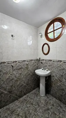 a bathroom with a sink and a window at CASA PARA 5 CON PILETa in Villa Carlos Paz