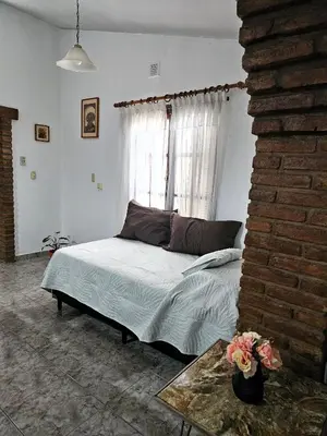 a bedroom with a bed and a window at CASA PARA 5 CON PILETa in Villa Carlos Paz