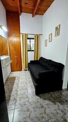 a bedroom with a black bed in a room at CASA PARA 5 CON PILETa in Villa Carlos Paz