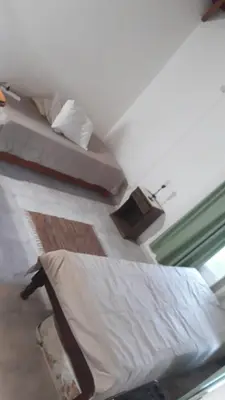 a bedroom with two beds and a window at Doña issaa in Merlo