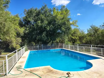 a swimming pool with a metal fence around it at Doña issaa in Merlo