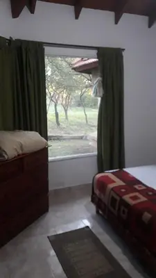 a bedroom with a bed and a large window at Doña issaa in Merlo