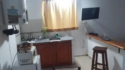 a small kitchen with a sink and a microwave at Doña issaa in Merlo