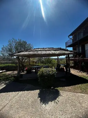 a picnic shelter with the sun in the sky at Cabañas EzeNic in Cavalango