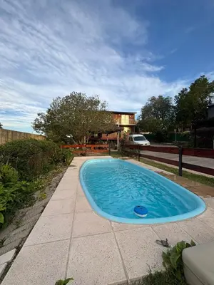 a swimming pool in the middle of a yard at Cabañas EzeNic in Cavalango