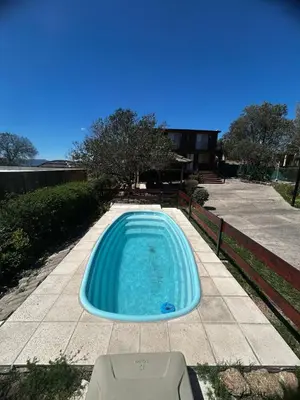 a swimming pool in the middle of a yard at Cabañas EzeNic in Cavalango