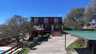 a house with a tennis court in front of it at Cabañas EzeNic in Cavalango