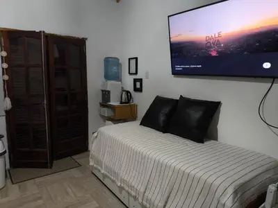 a bedroom with a bed with a flat screen tv on the wall at Las Carolas in Santa María