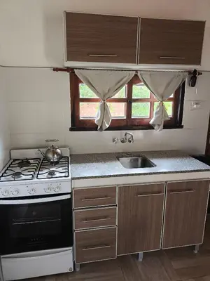 a kitchen with a stove and a sink at Las Carolas in Santa María