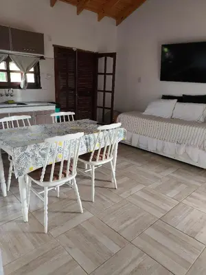 a dining room with a table and chairs and a bed at Las Carolas in Santa María