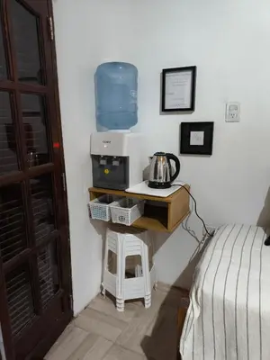 a room with a bed and a table with a microwave at Las Carolas in Santa María
