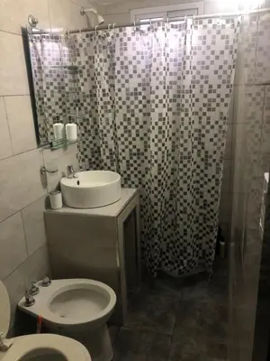 a bathroom with a sink and a toilet and a shower at La casa de nona in Villa Carlos Paz