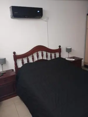 a bedroom with a bed and a television on the wall at La casa de nona in Villa Carlos Paz