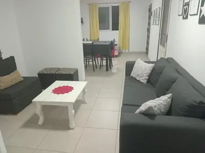 a living room with a couch and a table at La casa de nona in Villa Carlos Paz