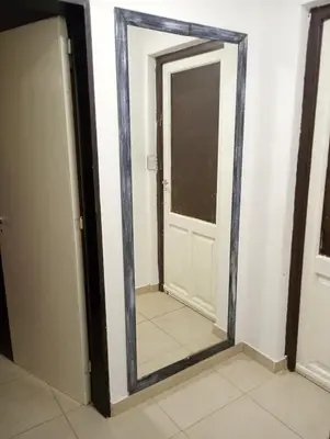 a mirror in front of a door in a room at La casa de nona in Villa Carlos Paz