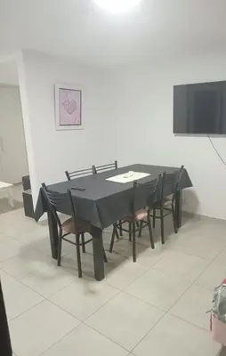 a black table and chairs in a room at La casa de nona in Villa Carlos Paz