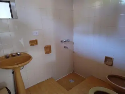 a bathroom with a shower with a sink and a toilet at Casa Arroyo in Villa Carlos Paz