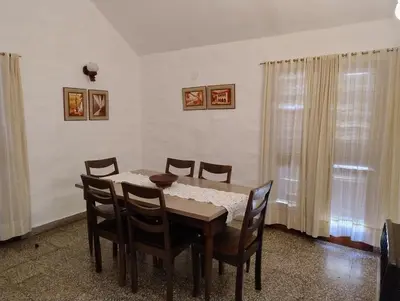 a dining room with a table and chairs at Casa Arroyo in Villa Carlos Paz