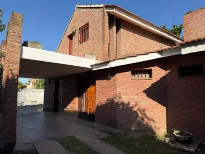 a red brick building with a large door and a brick at Casa Arroyo in Villa Carlos Paz