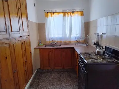 a kitchen with a stove and a sink at Casa Arroyo in Villa Carlos Paz