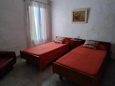 a room with two beds and a couch at Casa Arroyo in Villa Carlos Paz
