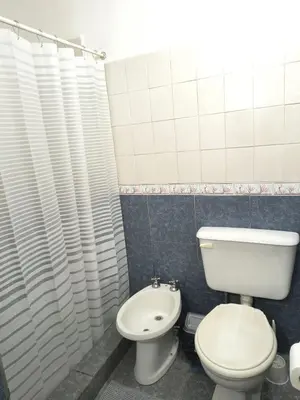 a bathroom with a toilet and a sink at Hosteria Champaqui in Los Hornillos