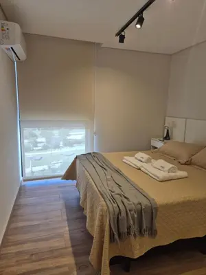 a bedroom with a bed with two towels on it at Hermoso Departamento en zona Quality Espacio, Hospital Privado Universitario de Córdoba in Cordoba