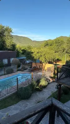 a view of a swimming pool with a mountain in the background at Alpinas del Valle in Santa Rosa de Calamuchita