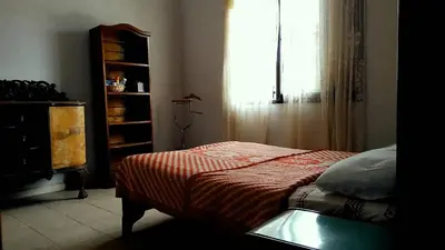 a bedroom with a bed and a window at Casa colibrí in Tanti