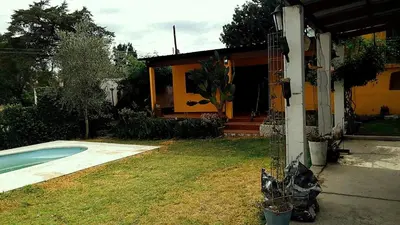 a house with a swimming pool in the yard at Casa colibrí in Tanti
