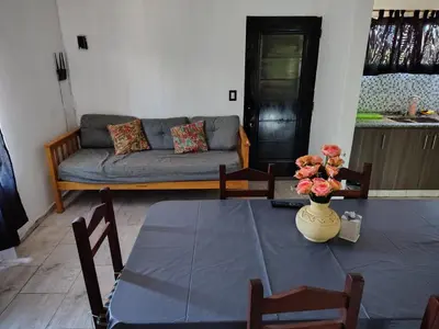 a living room with a table and a couch at Cabaña papáviejo in Villa de Las Rosas