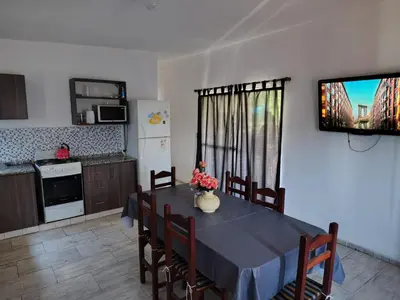 a kitchen with a table with a blue table cloth at Cabaña papáviejo in Villa de Las Rosas