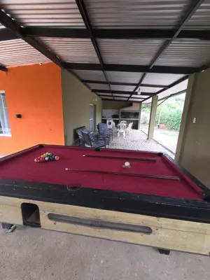 a room with a pool table in a house at Cabaña papáviejo in Villa de Las Rosas