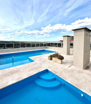 a swimming pool on the roof of a building at City Paz in Villa Carlos Paz
