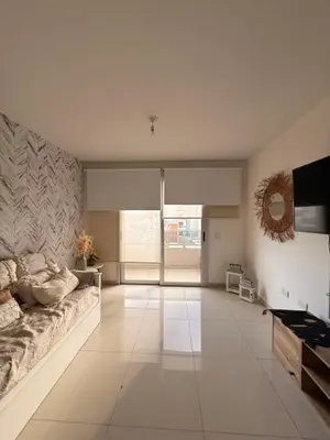 a living room with a couch and a television at City Paz in Villa Carlos Paz