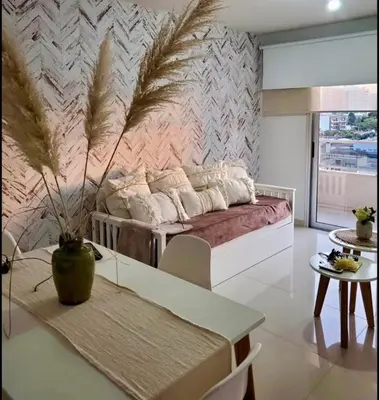 a living room with a couch and a table at City Paz in Villa Carlos Paz