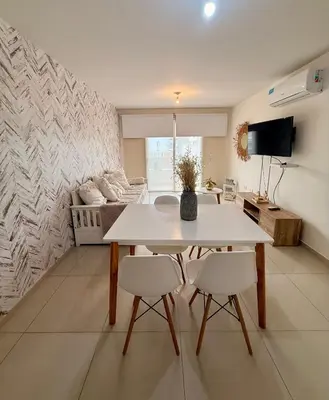 a living room with a table and two chairs at City Paz in Villa Carlos Paz