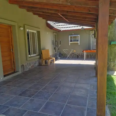 an outdoor patio with a wooden pergola at die lavendel chalet in Villa General Belgrano