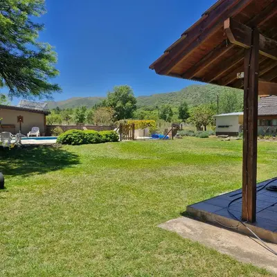 a view of a yard with a house and a trailer at die lavendel chalet in Villa General Belgrano