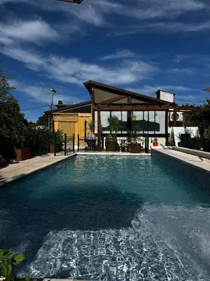 a swimming pool with a gazebo in a house at PurinkiWasi - La casa de todos in Los Reartes
