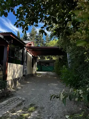 a bridge over a road next to a building at PurinkiWasi - La casa de todos in Los Reartes