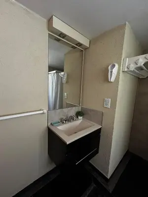 a bathroom with a sink and a mirror at PurinkiWasi - La casa de todos in Los Reartes